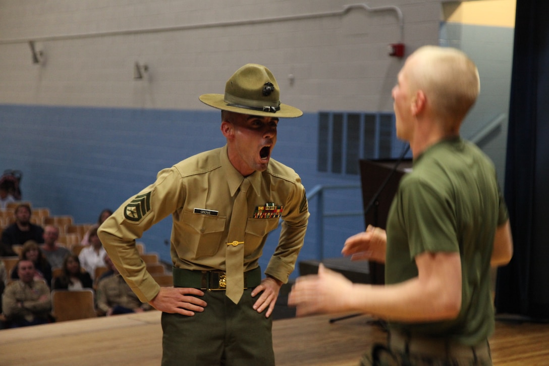 Staff Sergeant David L. Grove, a drill instructor assigned to MCRD Parris Island, SC, 3rd Recruit Training Battalion, and a Marine on recruiter's assistant displays what incentive training consists of during recruit training as RS Nashville's annual poolee Family Night. Family Night is a night dedicated to answering questions parents may have and giving the poolees a small taste of what recruit training will be like