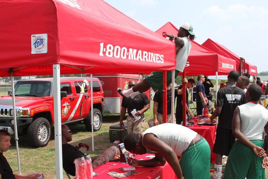 Participants of the MS 7 on 7 Football Tournament, held at Shiloh Park, Brandon, MS, conduct pull ups to earn Marine Corps gear.