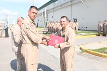 Marine Aircraft Group 26 Commanding Officer Col. Christopher Seymour presents Lt. Col. Christopher J. Boniface, commanding officer of Marine Medium Tiltrotor Squadron 266, the 2011 Aviation Safety Award, Aug. 1. 
