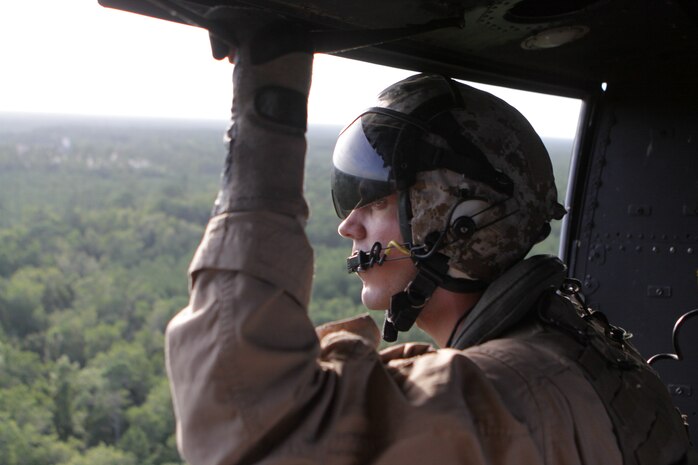Lance Cpl. Barry C. Clem, Marine Light Attack Helicopter Squadron 269 crew chief, watches outside the UH-1Y Huey to ensure that it is clear of any obstacles, Aug. 9. 