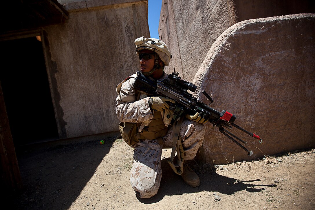 Lance Cpl. Nicolas Bourgeois, a rifleman with 2nd Platoon, India Company, 3rd Battalion, 3rd Marine Regiment, and 20-year-old native of Ft. Worth, Texas, provides security while patrolling through a simulated urban village during non-lethal weapons training on Marine Corps Training Area Bellows, Hawaii, Aug. 15, 2012. The training was part of a two-week test readiness review fielded by the Quantico, Va.-based Joint Non-Lethal Weapons Directorate and the Marine Corps Forces, Pacific Experimentation Center. The DoD Non-Lethal Weapons Program, headed by Commandant of the Marine Corps Gen. James Amos, trains operating forces on escalation of force options to minimize casualties and collateral damage, said Kelley Hughes, a directorate spokesperson.