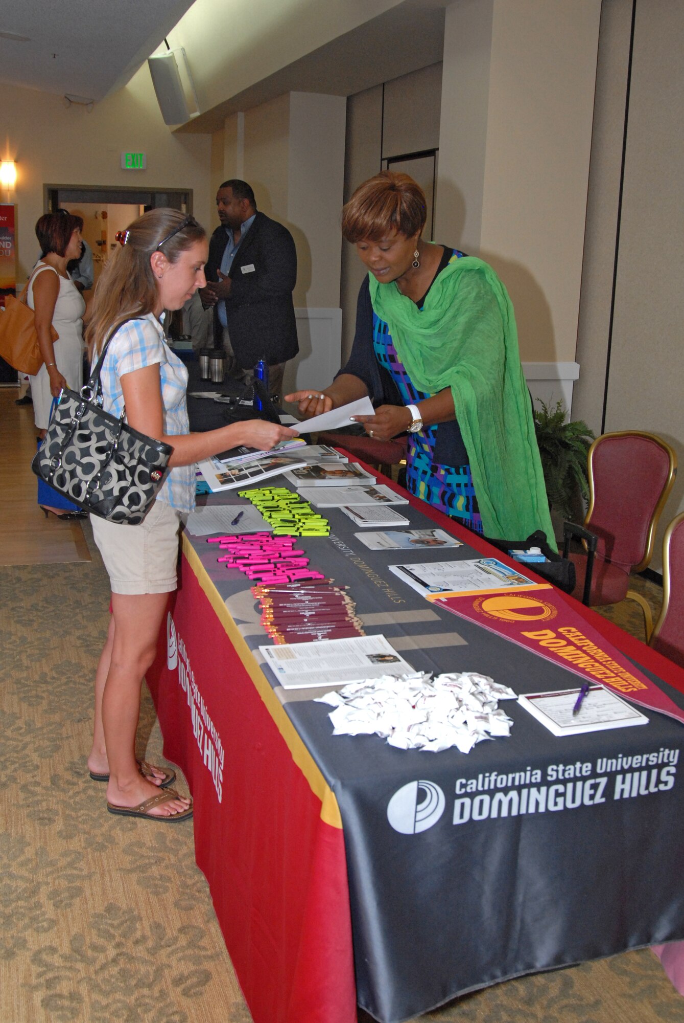 College representatives such as this one from California State Dominguez Hills got to meet and greet prospective students and those wanting to continue their education.  Forty colleges came from as far as Hawai'i to attend this year's Education Fair sponsored by the Edwards Air Force Base Education Center, Aug. 15. (U.S. Air Force photo by Kenji Thuloweit)