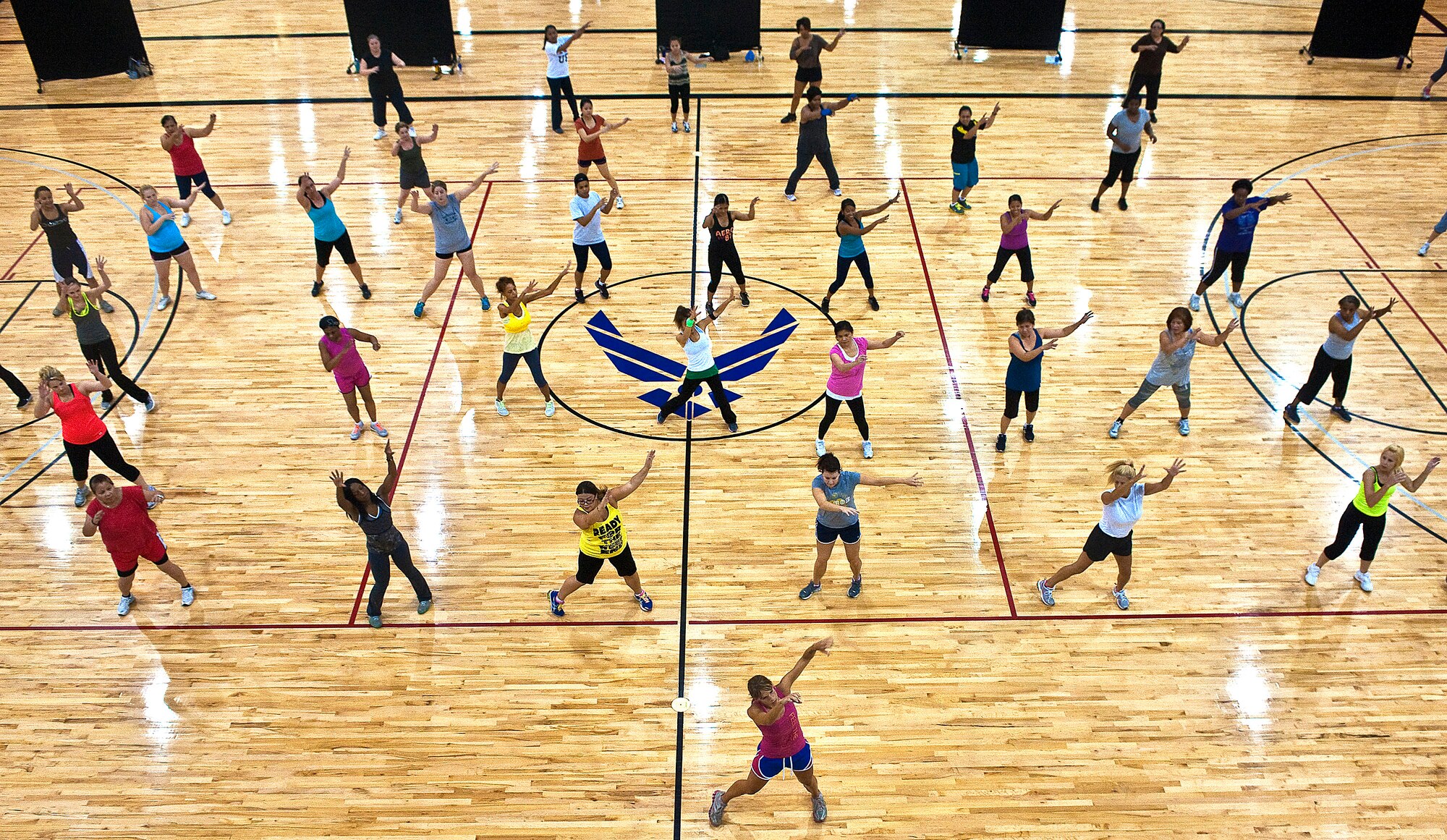 Military and family members participate in a Zumba fitness class at the Warrior Fitness Center Aug. 16, 2012, at Nellis Air Force Base, Nev. Zumba, a Colombian dance fitness program, is offered at the Warrior Fitness Center every Thursday. (U.S. Air Force photo by Staff Sgt. Christopher Hubenthal)