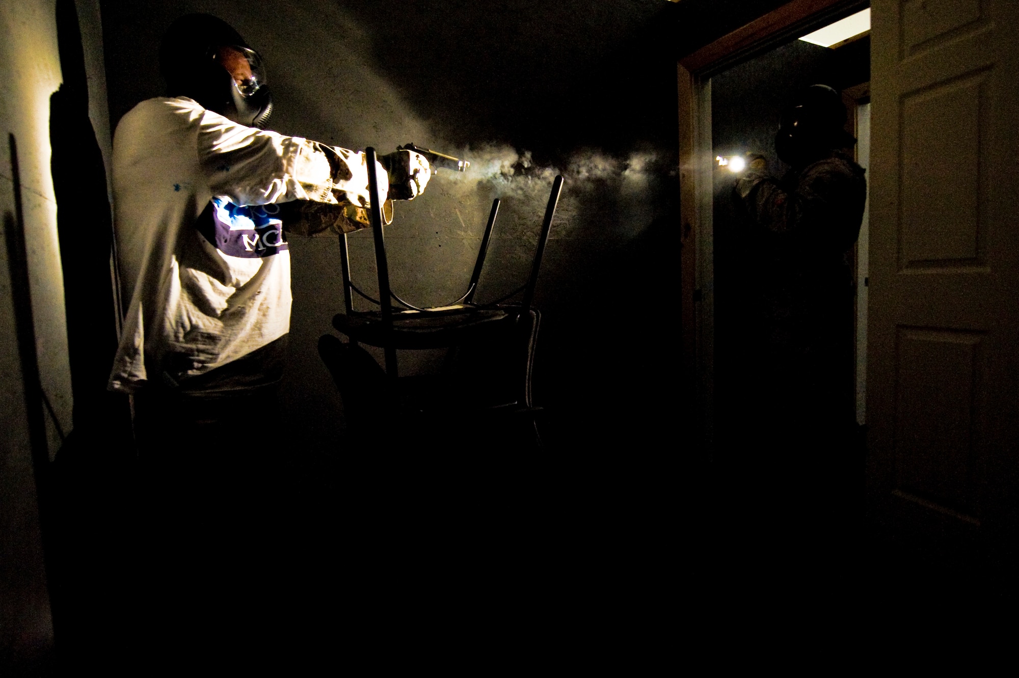 Defenders from the 99th Security Forces Squadron exchange fire during a shoot-no-shoot exercise at the 99th SFS shoothouse Aug. 15, 2012, at Nellis Air Force Base, Nev. Shoot-no-shoot exercises test the abilities of law enforcement personnel to respond to an emergency, use the appropriate amount of force and keep innocent bystanders safe. (U.S. Air Force photo by Staff Sgt. William P.Coleman)
  

