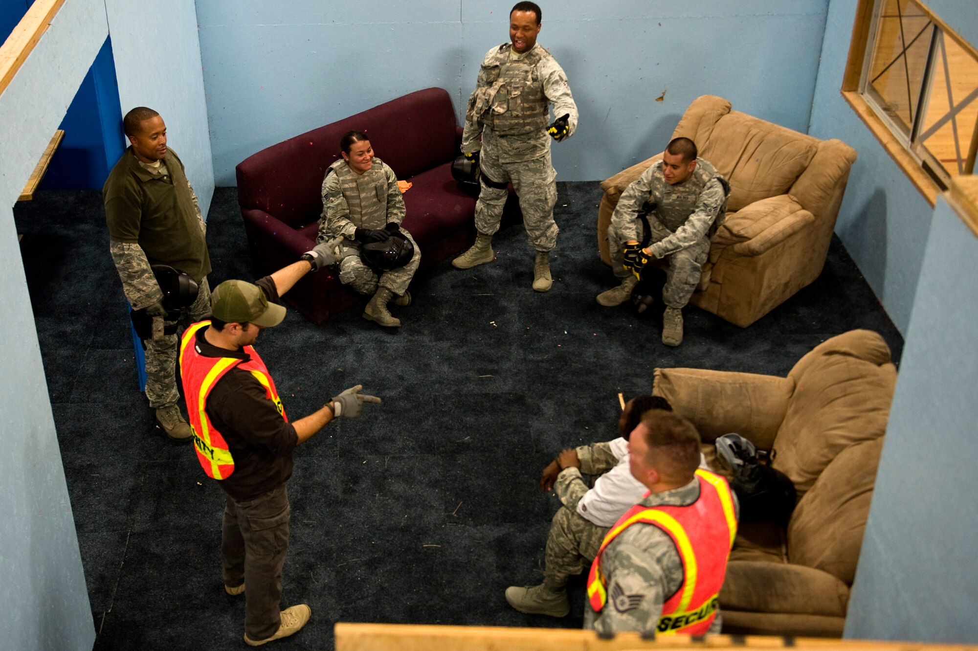 Members from the 99th Security Forces Squadron provide feedback to each other after an exercise at the 99th SFS shoothouse Aug. 15, 2012, at Nellis Air Force Base, Nev. Instructors observe trainees using a cat walk, sixteen video cameras and by participating in the exercises. (U.S. Air Force photo by Staff Sgt. William P.Coleman)
  

