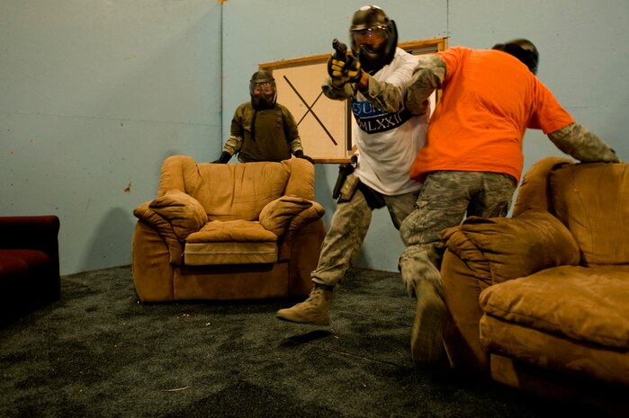 Defenders from the 99th Security Forces Squadron participate in a shoot-no-shoot exercise at the 99th SFS shoothouse Aug. 15, 2012, at Nellis Air Force Base, Nev. Shoot-no-shoot exercises test the abilities of law enforcement personnel to respond to an emergency, use the appropriate amount of force and keep innocent bystanders safe. (U.S. Air Force photo by Staff Sgt. William P.Coleman)  