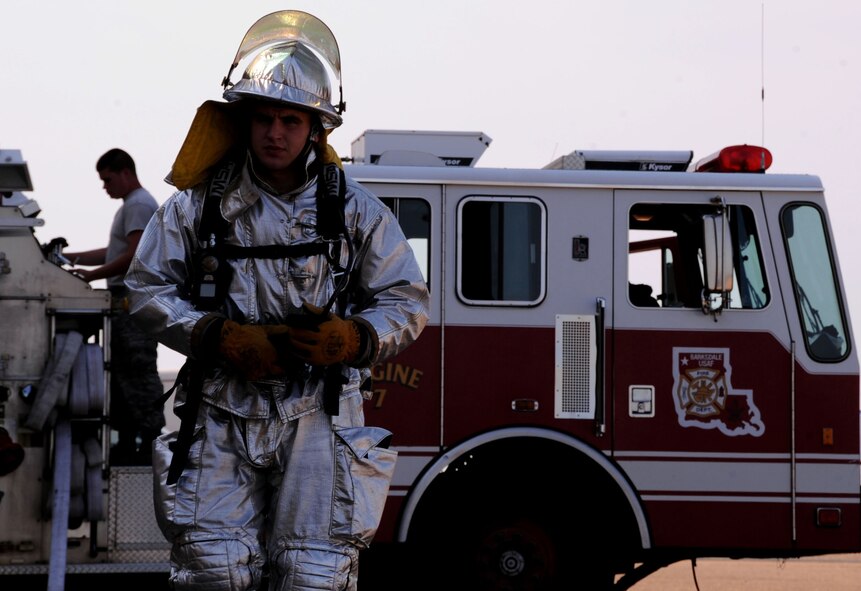 Airman 1st Class Xavier Bailey, 2nd Civil Engineer Squadron firefighter, snaps on a self-contained breathing apparatus pack before training on Barksdale Air Force Base, La., Aug. 14. The SCBA supplies up to an hour of oxygen. Bailey received a perfect score on his career development course end-of-course exam. (U.S. Air Force/photo Senior Airman La'Shanette V. Garrett)(RELEASED)