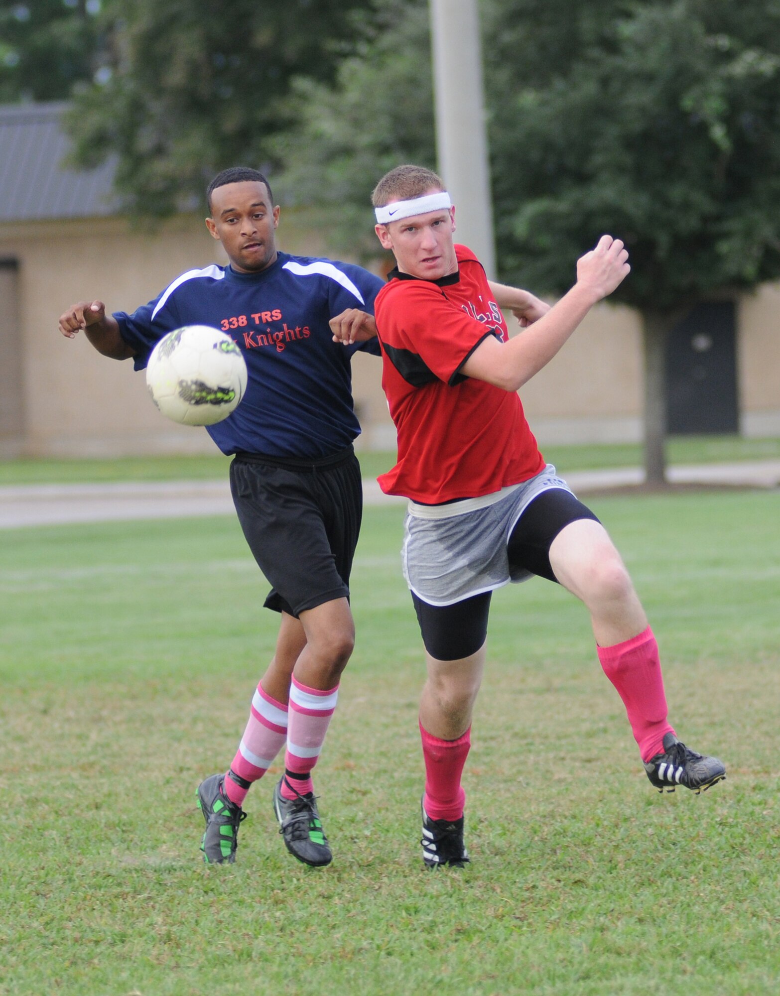 Ryan King, 338th Training Squadron, battles for the ball with Tyler Ungerer-Stevens, 335th TRS during an intramural soccer game Aug. 16, 2012, at Keesler Air Force Base, Miss.  The Dark Knights defeated the Bulls 4-3.  (U.S. Air Force photo by Kemberly Groue)