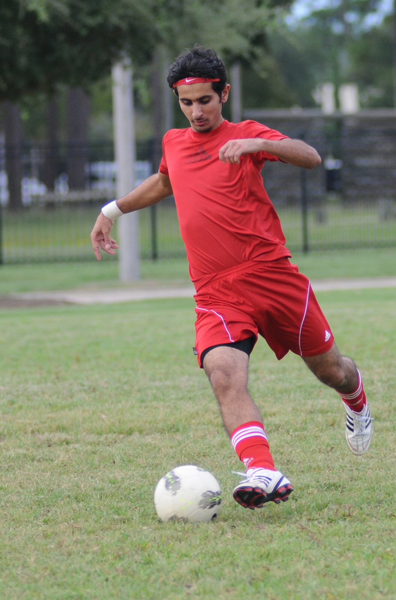 Sammy Alqahtan, 335th Training Squadron, dribbles the ball down the field during an intramural soccer game against the 338th TRS Aug. 16, 2012, at Keesler Air Force Base, Miss.  The Dark Knights defeated the Bulls 4-3.  (U.S. Air Force photo by Kemberly Groue)