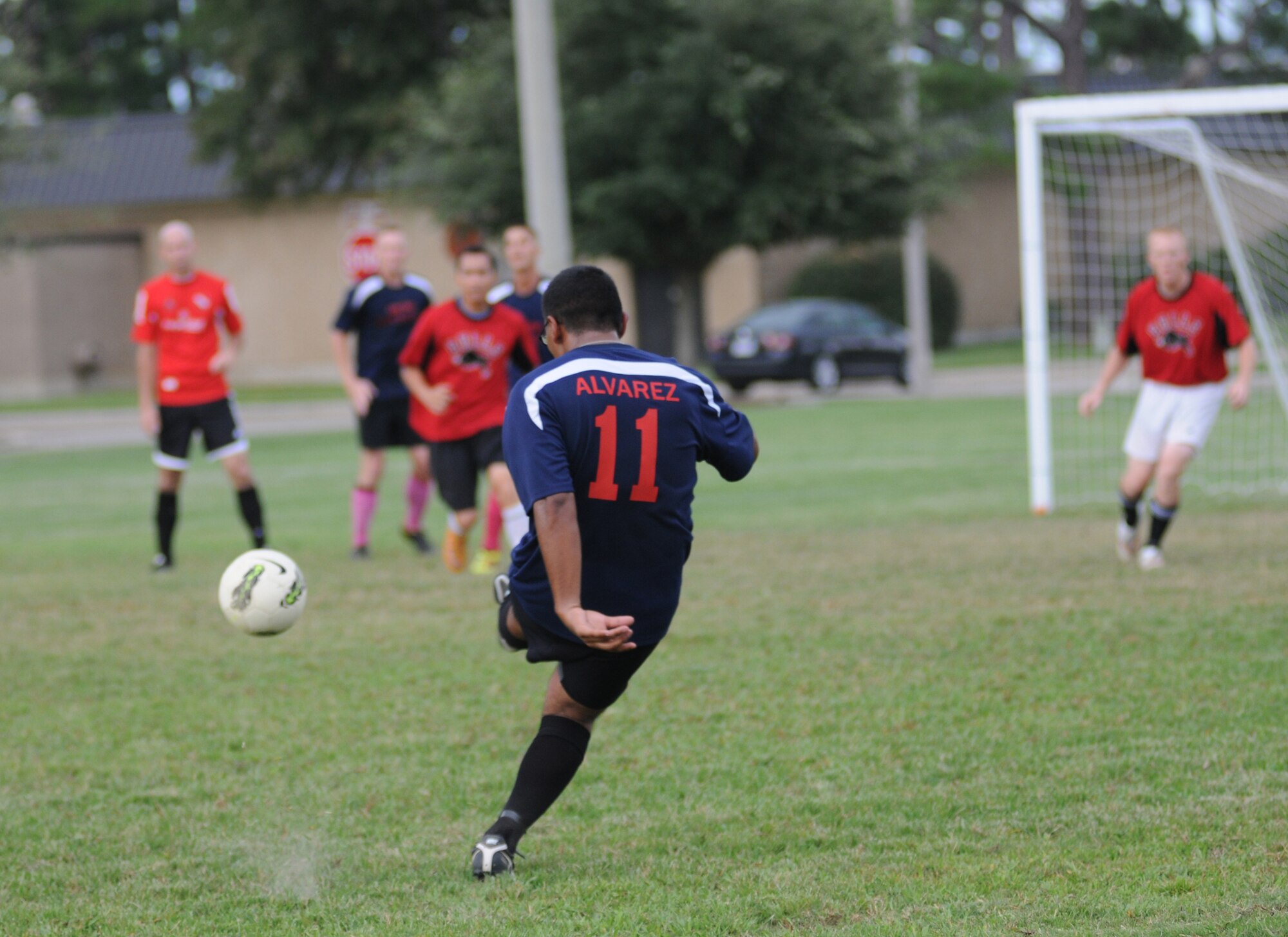 Roger Alvarez, 338th Training Squadron sends the ball across the field toward a teammate for closer access to the goal during an intramural soccer game against the 335th TRS Aug. 16, 2012, at Keesler Air Force Base, Miss.  The Dark Knights defeated the Bulls 4-3.  (U.S. Air Force photo by Kemberly Groue)