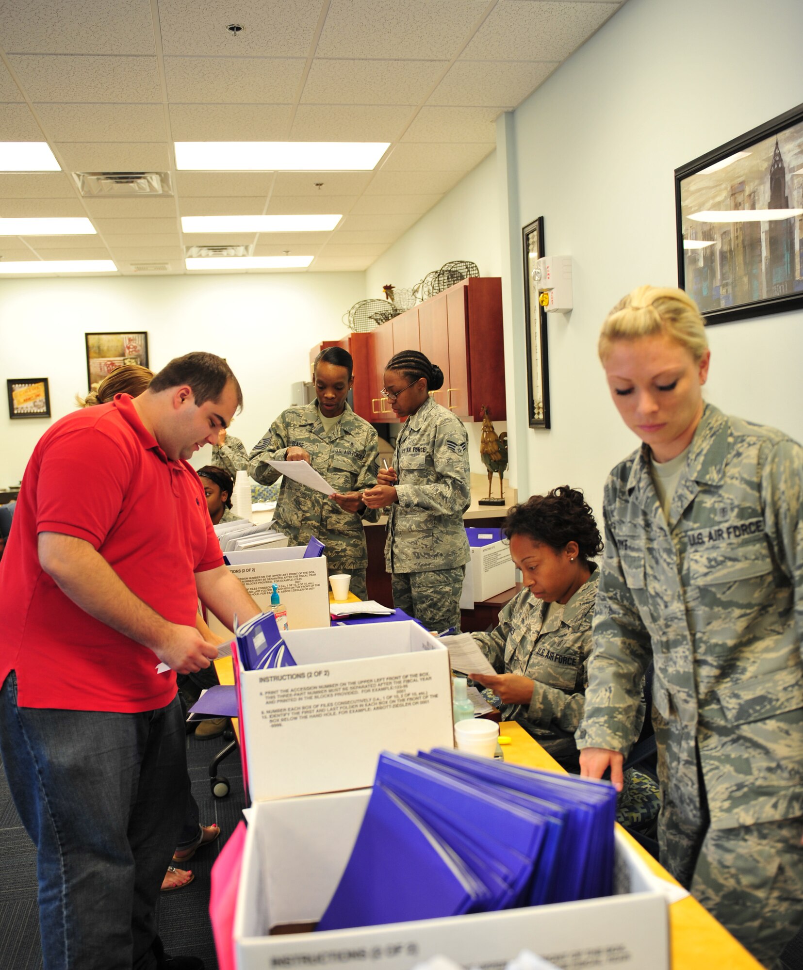 Airmen from the 23d Aerospace Medicine Squadron, public health technicians, in-process Individual Ready Reserve members during an IRR muster at Moody Air Force Base, Ga., Aug. 18, 2012. Public health technicians also handed out temporary medical records to about 100 IRR members and ensured that each member had all the paperwork needed for the muster. (U.S. Air Force photo by Staff Sgt. Stephanie Mancha/ Released)
