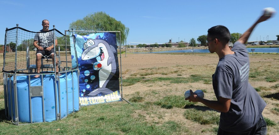 WHITEMAN AIR FORCE BASE, Mo. -- A member of Team Whiteman attempts to dunk Master Sgt. Trapper Otto, 509th Communications Squadron first sergeant, at the dunk tank during the Atomic Luau, Aug. 17. All first sergeants on base participated in the dunk tank. (U.S. Air Force photo/Airman 1st Class Bryan Crane) (Released)