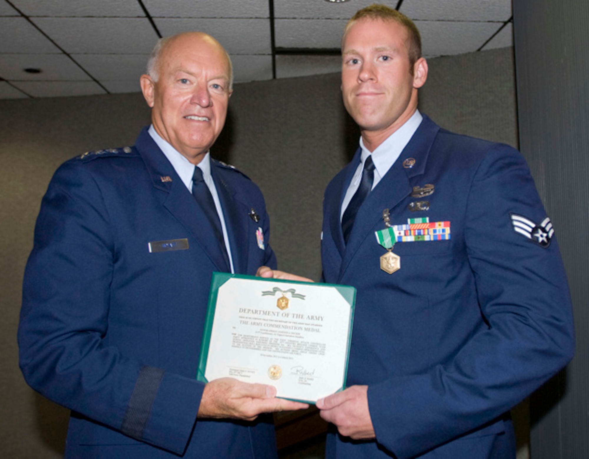 Senior Airman Jameson Decker, 146th Air Support Operations Squadron, is presented the Army Commendation Medal by Lt. Gen. Harry M. Wyatt III, Director Air National Guard, on August 18, 2012 for meritorious service while assigned as Joint Terminal Attack Controllers in support of the 45th Infantry Brigade Combat Team during Operations Enduring Freedom.  Senior Airman Decker was deployed from November 2011 through March 2012.  (U.S. Air Force Photo by Tech. Sgt. Roberta A. Thompson) (Released)