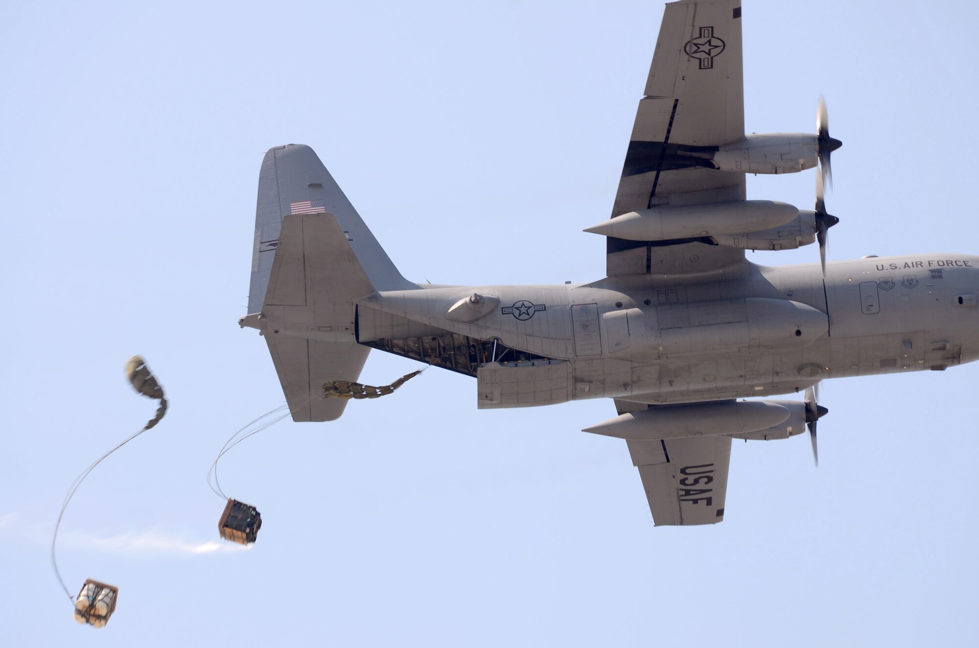 Palletized cargo is air dropped to demonstrate the capability to members of the Honorary Commanders Association visiting Dobbins Air Reserve Base, Aug 16. The 2012 Honorary Commanders Association visited Dobbins Air Reserve Base as part of their year-long introduction to the military.  (U.S. Air Force photo/Brad Fallin)