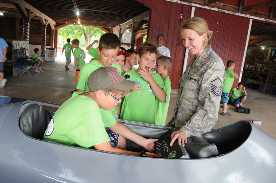 Master Sgt. Jaime Brown a retention office manager, from the 180th Fighter Wing, chaperon’s boy scouts out of northern Ohio, as they take turns in the mini F-16 at White Star Park, Gibsonburg, Ohio, July 26, 2012.  Each year the camp program has a different theme; this year’s theme consisted of American Heroes, which included military members, Ottawa county Sheriff’s office, the Port Clinton police K9 unit and a local fire department underwater rescue team.  (U.S. Air Force photo by Senior Airman Amber Williams/Released)