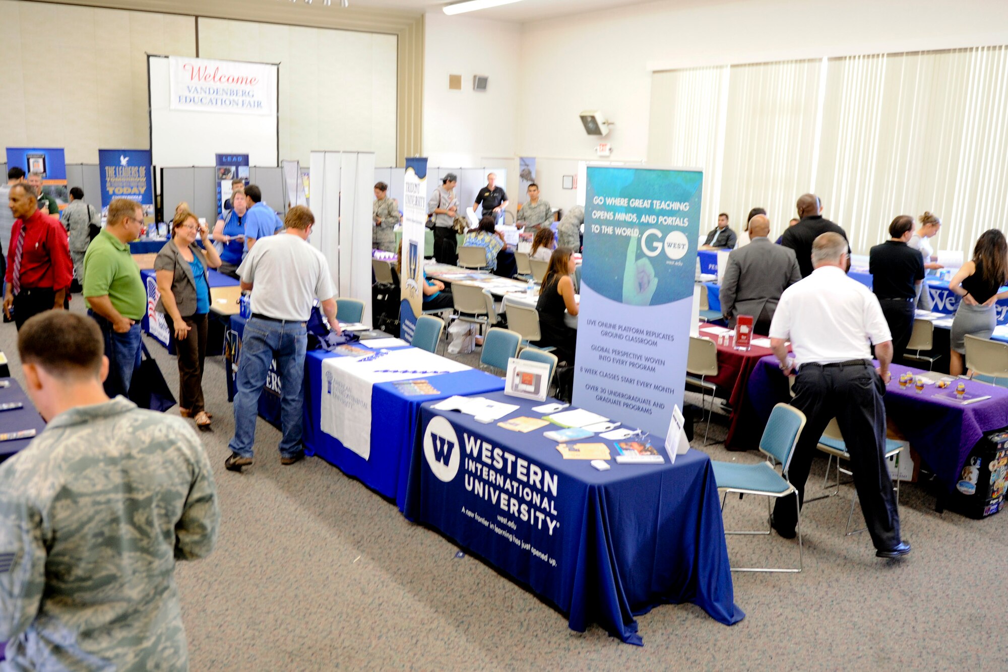 VANDENBERG AIR FORCE BASE, Calif. -- Team V members look over college displays at an education fair here Thursday, August 16, 2012. The fair, held at the Base Education Center here, had more than 50 colleges and programs present and was open to anyone with base access. (U.S. Air Force photo/Staff Sgt. Levi Riendeau)
