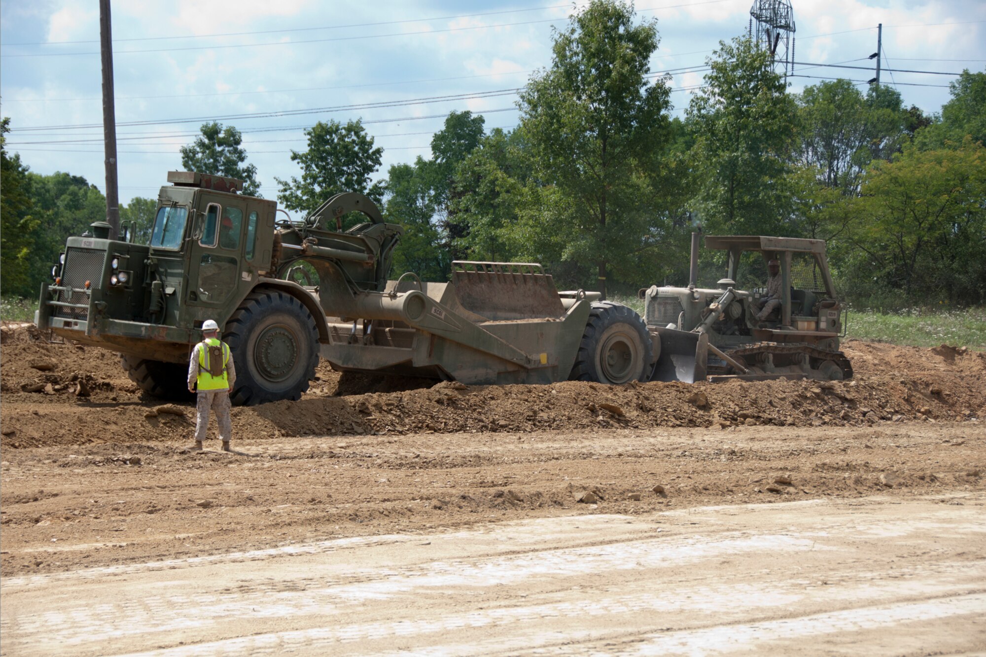 KENSINGTON, Ohio — A U.S. Marine Corps Reservist operates heavy equipment Aug. 15, 2012 during a land excavating project at Seven Ranges Scout Camp here. Airmen, Marines and Sailors from YARS participated in a two-week joint training exercise at the camp and worked together to improve roads and drainage systems, erect campsites and excavate land for future projects. U.S. Air Force photo by Tech. Sgt. Brenda Haines/Released