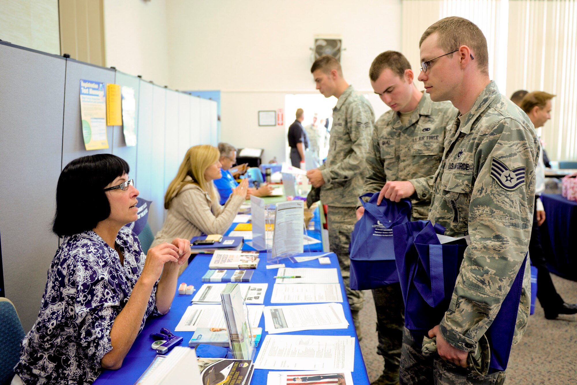 VANDENBERG AIR FORCE BASE, Calif. -- Airmen speak with Dorian Hodge, the 30th Force Support Squadron Community College of the Air Force advisor, about their CCAF and what steps to take to complete it at an education fair here Thursday, August 16, 2012. The fair, held at the Base Education Center here, had more than 50 colleges and programs present and was open to anyone with base access. (U.S. Air Force photo/Staff Sgt. Levi Riendeau)
