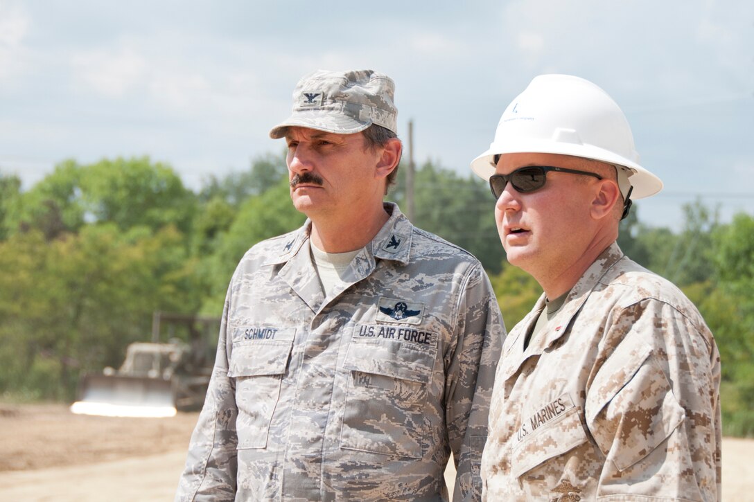 KENSINGTON, Ohio — U.S. Air Force Reserve Col. Reinhard Schmidt, commander of the 910th Airlift Wing based at Youngstown Air Reserve Station, Ohio, is briefed by U.S. Marine Corps Reserve Chief Warrant Officer 3 Mike Lockhart, commanding officer of Landing Support Equipment Company, Aug. 15, 2012 about the ground leveling progress at Seven Ranges Scout Camp here. Airmen, Marines and Sailors from YARS participated in a two-week joint training exercise at the camp and worked together to improve roads and drainage systems, erect campsites and excavate land for future projects. U.S. Air Force photo by Tech. Sgt. Brenda Haines/Released