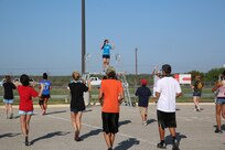 JoBeth Guzman, Randolph High School band head drum major, leads the band in warmup drills as the band practices in the early morning heat at Randolph, Aug. 14. The band is learning fundamentals of drill to prepare for the upcoming marching season. (U.S. Air Force photo by Rich McFadden) 