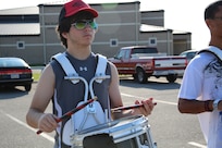 Mathew Thornton, Randolph High School band drummer plays the cadence as the band practices in the early morning heat at Randolph, Aug. 14. The band is learning fundamentals of drill to prepare for the upcoming marching season. (U.S. Air Force photo by Rich McFadden) 