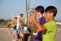 Austin Hill (right) and Thomas Brock, Randolph High School band, line up with the brass section as the band practices in the early morning heat at the high school, Aug. 14. The band is learning fundamentals of drill to prepare for the upcoming marching season. (U.S. Air Force photo by Rich McFadden) 