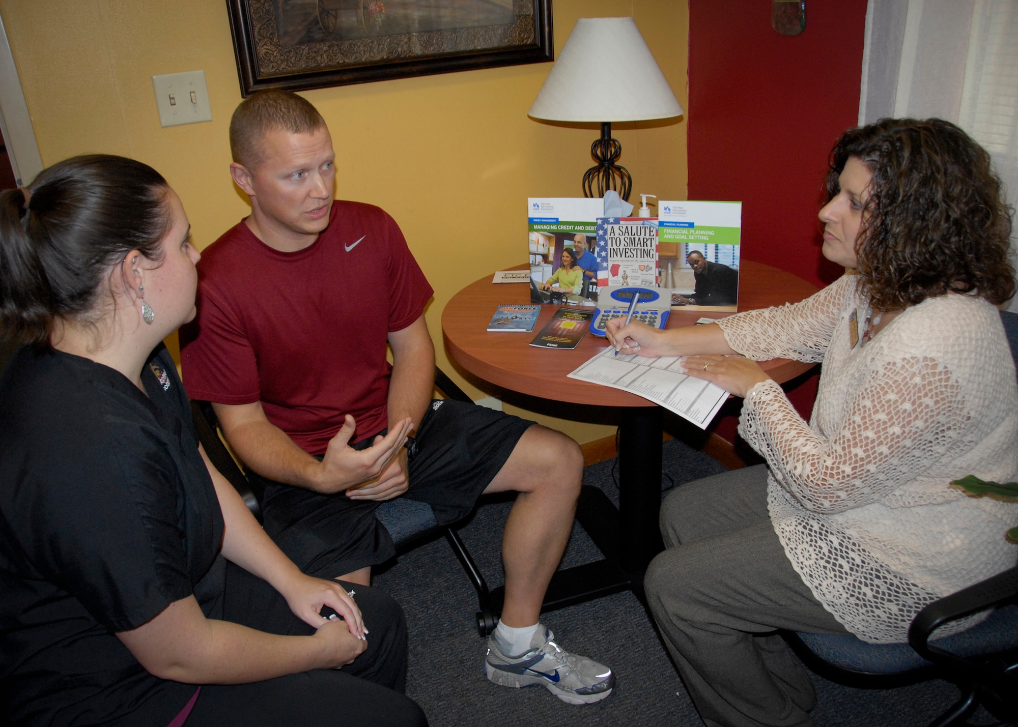 Angela Teixeira, an Airman and Family Readiness Center community readiness consultant, presents financial strategies to Tech. Sgt. Thomas Piening, a member of the 33rd Maintenance Group, and his wife, Sarah.  Eglin’s A&FRC’s personal financial readiness program offers classes on a mandatory, regular, bi-monthly, monthly and quarterly basis, as well as guidance by appointment.  (U.S. Air Force photo/Kevin Gaddie)