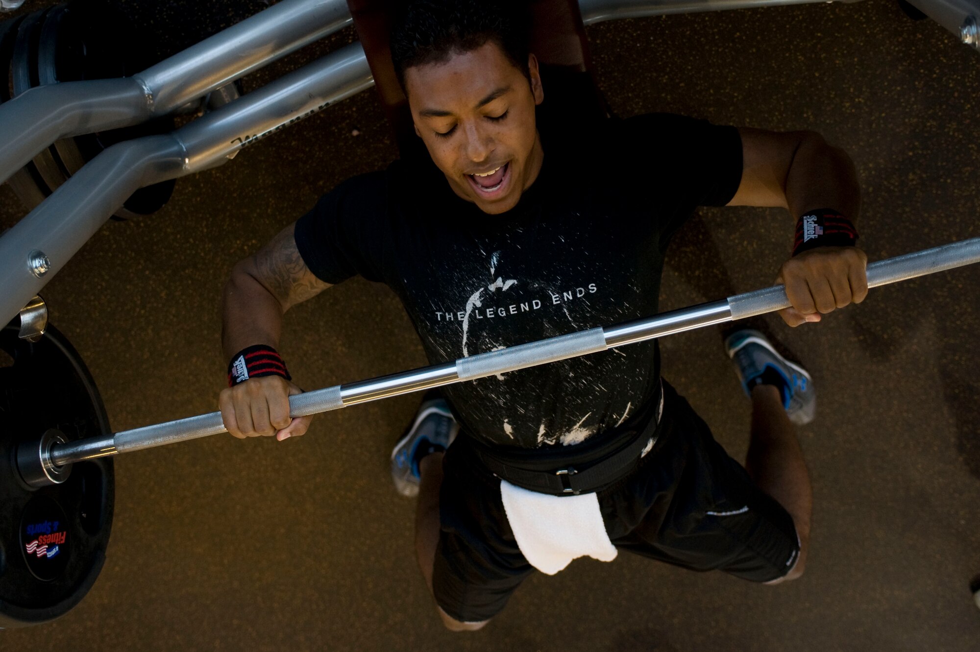 A U.S. Air Force Airman bench presses during a powerlifting competition at the Warrior Fitness Center Aug. 15, 2012, at Nellis Air Force Base, Nev. Competitors are ranked based on the Schwartz Formula for men and Malone Formula for women which takes away individual weight classes. (U.S. Air Force photo by Airman 1st Class Christopher Tam)