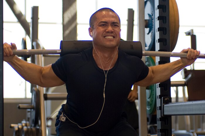 U.S. Air Force Staff Sgt. Aric Andrade, 99th Civil Engineering Squadron firefighter crew chief, squats during a powerlifting competition at the Warrior Fitness Center Aug. 15, 2012, at Nellis Air Force Base, Nev. Andrade competed pound for pound with no separate weight classes. (U.S. Air Force photo by Airman 1st Class Christopher Tam)