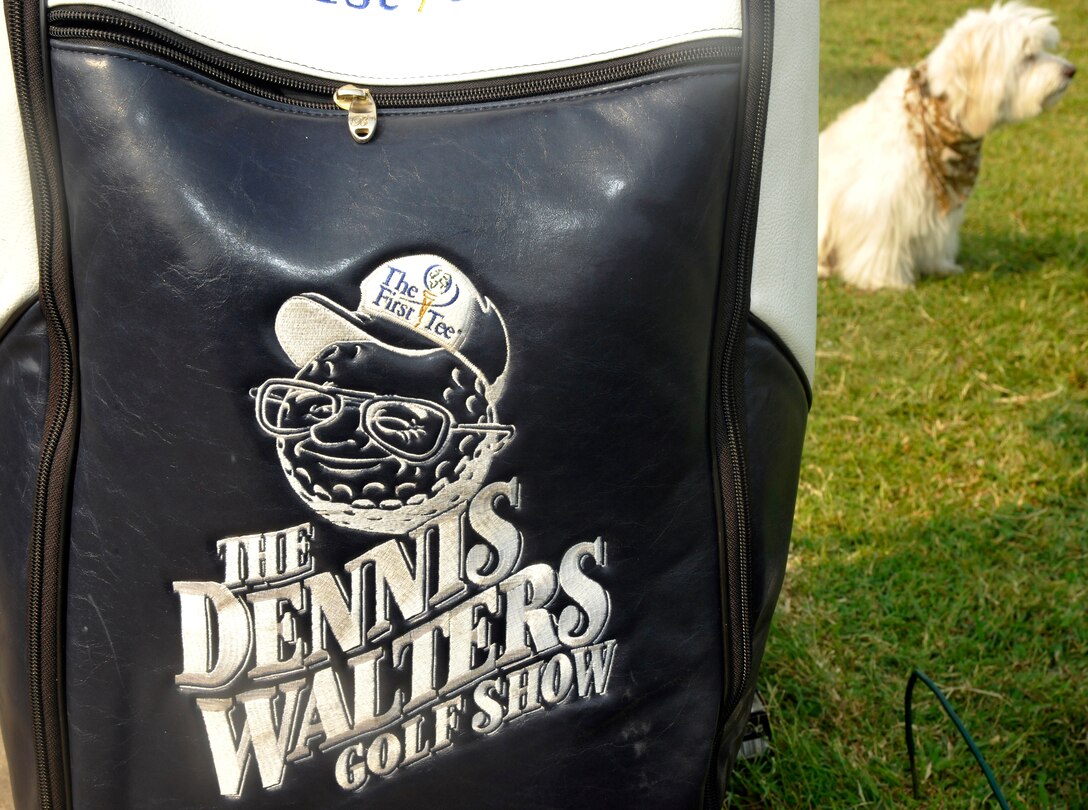 Bucky, highlight of The Dennis Walters Golf Show, waits for instruction behind a golf bag at the Club at Andrews Aug. 17, 2012. Dennis Walters, who is paralyzed from the waist down, his dog Bucky, and their assistant Asher Grogg, tour the nation as The Dennis Walters Golf Show. Their show encourages viewers to continually pursue their dreams despite life's challenges. (U.S. Air Force photo/Senior Airman Lindsey Porter)