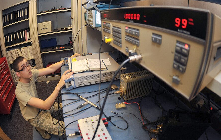 RAF Mildenhall, England - Airman 1st Class Weston Williams, 100th Communications Squadron, performs a modulation check during a maintenance inspection of a PRC-113 tactical radio  Aug. 17, 2012, in Bldg. 568. The radio is used by personnel in the air traffic control tower and command post as a means of ground to air communication. (U. S. Air Force photo/Senior Airman Jerilyn Quintanilla)  