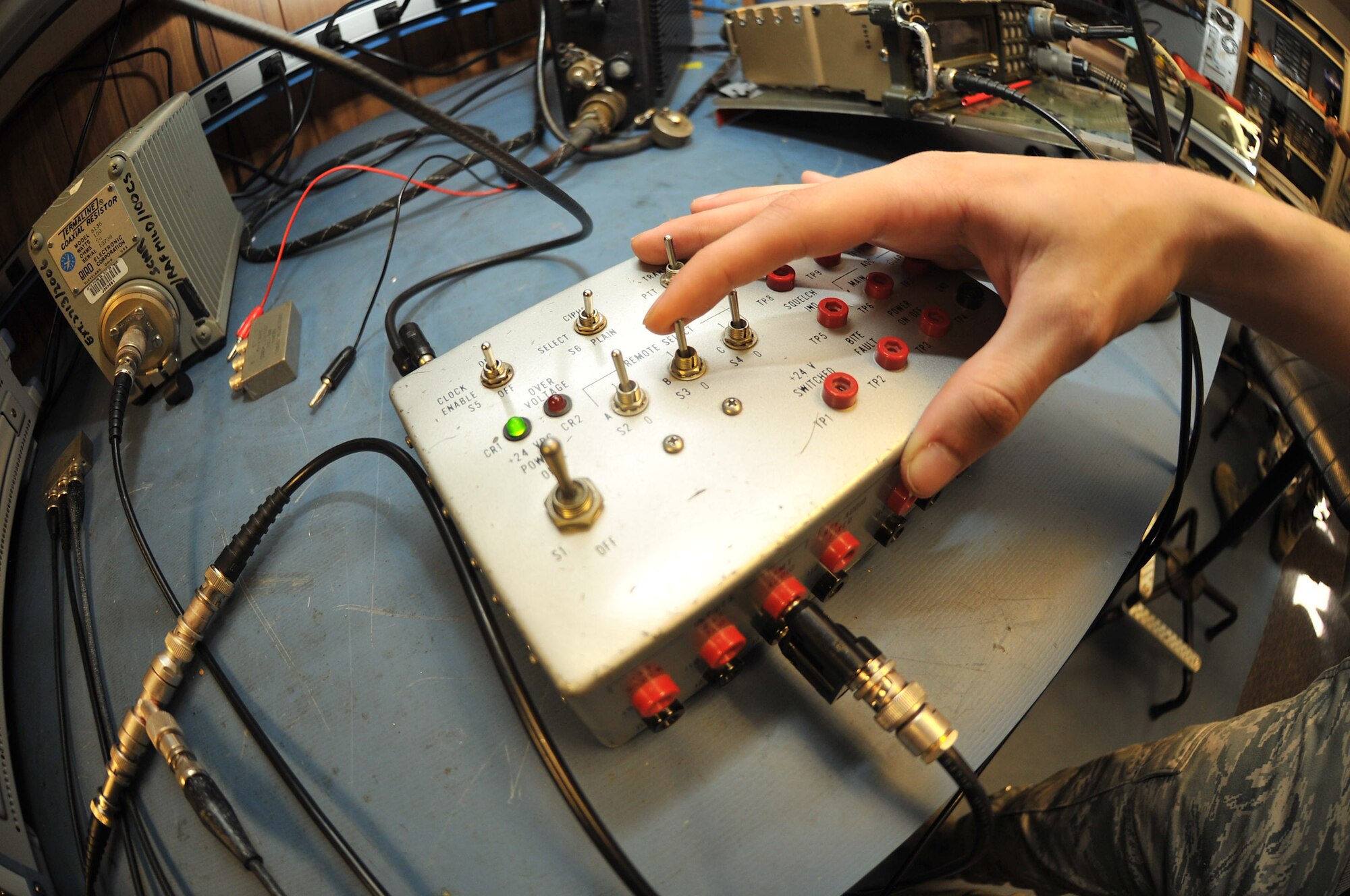 RAF MILDENHALL, England – Airman 1st Class Weston Williams, 100th Communications Squadron, uses a test set to do a voltage check during a maintenance inspection of a PRC-113 tactical radio Aug. 17, 2012, in Bldg. 568. Airmen assigned to the transmissions systems section of the 100th CS are responsible for all radio communication and mass alert systems on base. (U.S. Air Force photo/Senior Airman Jerilyn Quintanilla)