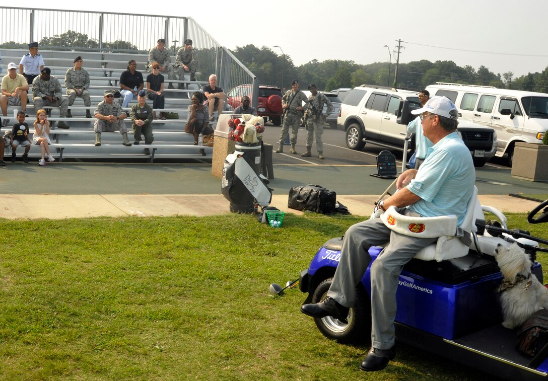 Dennis Walters, Andrews Leadership Series guest speaker, takes questions from the audience Aug. 17, 2012 before starting his golf show at the Club at Andrews. Walters, who is paralyzed from the waist down, his dog Bucky, and their assistant Asher Grogg, tour the nation as The Dennis Walters Golf Show. Their show encourages viewers to continually pursue thier dreams despite life's challenges. (U.S. Air Force photo/Senior Airman Lindsey Porter)