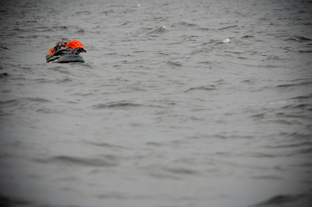 Airman 1st Class Taras Ivaniuk plays the role of a downed pilot during water rescue training in the Gulf of Mexico on Aug. 14, 2012. The exercise tested 347th Rescue Group members' ability to locate and rescue downed personnel in open water. Ivaniuk is a 38th Rescue Squadron pararescueman from Moody Air Force Base, Ga. (U.S. Air Force photo/Staff Sgt. Joshua J. Garcia)