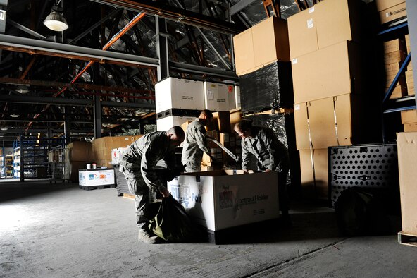 Staff Sgt. Erick Bartels, Staff Sgt. Caleb Gibson and Airman 1st Class Michele Grove inventory equipment inside a box at Joint Base Andrews, Md., Aug. 15, 2012. The Airmen are biomedical equipment technicians assigned to the Medical Logistics Flight of the 779th Medical Support Squadron. (U.S. Air Force photo/Val Gempis)