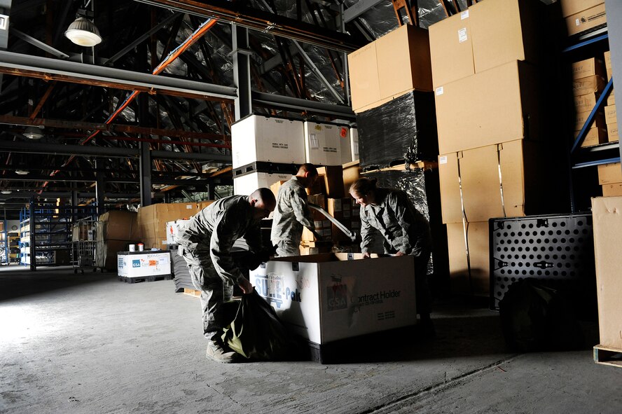 Staff Sgt. Erick Bartels, Staff Sgt. Caleb Gibson and Airman 1st Class Michele Grove inventory equipment inside a box at Joint Base Andrews, Md., Aug. 15, 2012. The Airmen are biomedical equipment technicians assigned to the Medical Logistics Flight of the 779th Medical Support Squadron. (U.S. Air Force photo/Val Gempis)