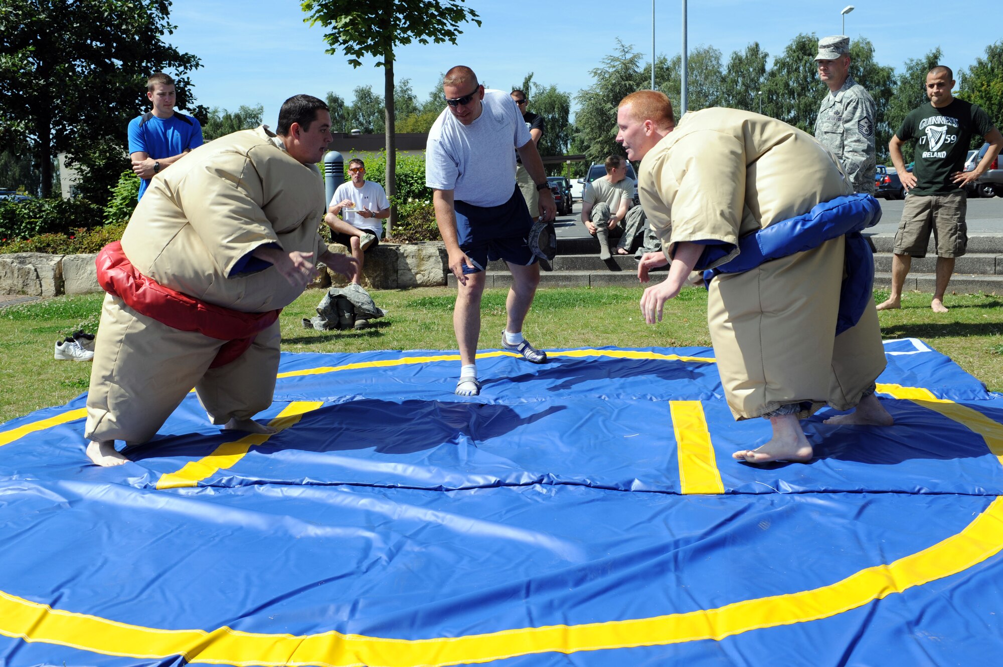 SPANGDAHLEM AIR BASE, Germany – Airman 1st Class Corey Kingsbury, American Forces Network Detachment Nine, and Senior Airman Kodie Hinz, 606th Air Control Squadron, prepare to face off during a sumo wrestling match during an unaccompanied Airmen block party at the wing pavilion here Aug. 17. The event included a drunk goggles obstacle course, sumo wrestling, Polynesian dancers, a dunk tank and a comedy performance. The first sergeants council and the Spangdahlem chiefs group hosted the event. (U.S. Air Force photo by Senior Airman Christopher Toon/Released)