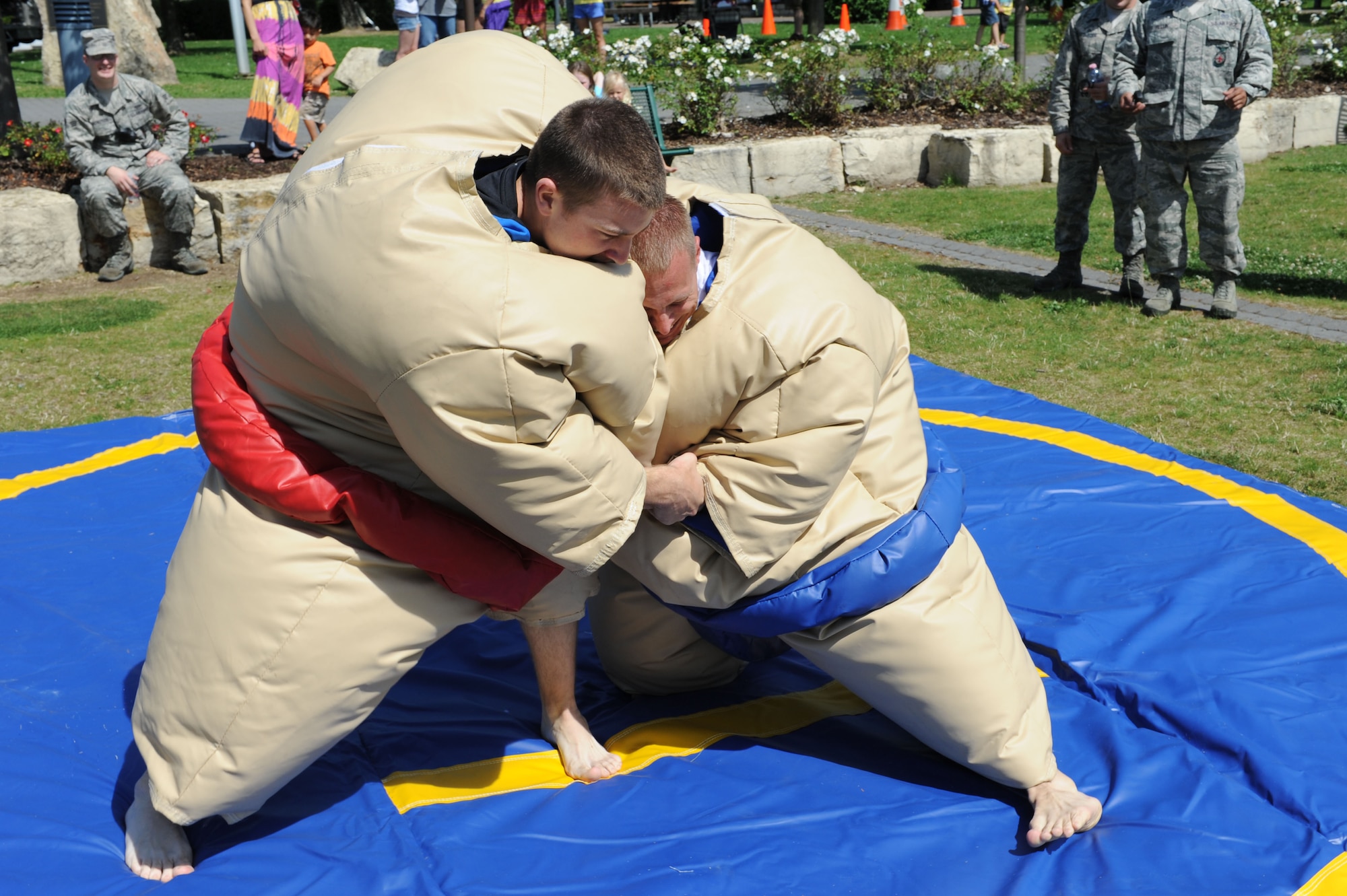 SPANGDAHLEM AIR BASE, Germany – Airman 1st Class Jeremy Heinen, 52nd Civil Engineer Squadron, left, and Chief Master Sgt. Matthew Grengs, 52nd Fighter Wing command chief, sumo wrestle during an unaccompanied Airmen block party at the wing pavilion here Aug. 17. The event included a drunk goggles obstacle course, sumo wrestling, Polynesian dancers, a dunk tank and a comedy performance. The first sergeants council and the Spangdahlem chiefs group hosted the event. (U.S. Air Force photo by Senior Airman Christopher Toon/Released)