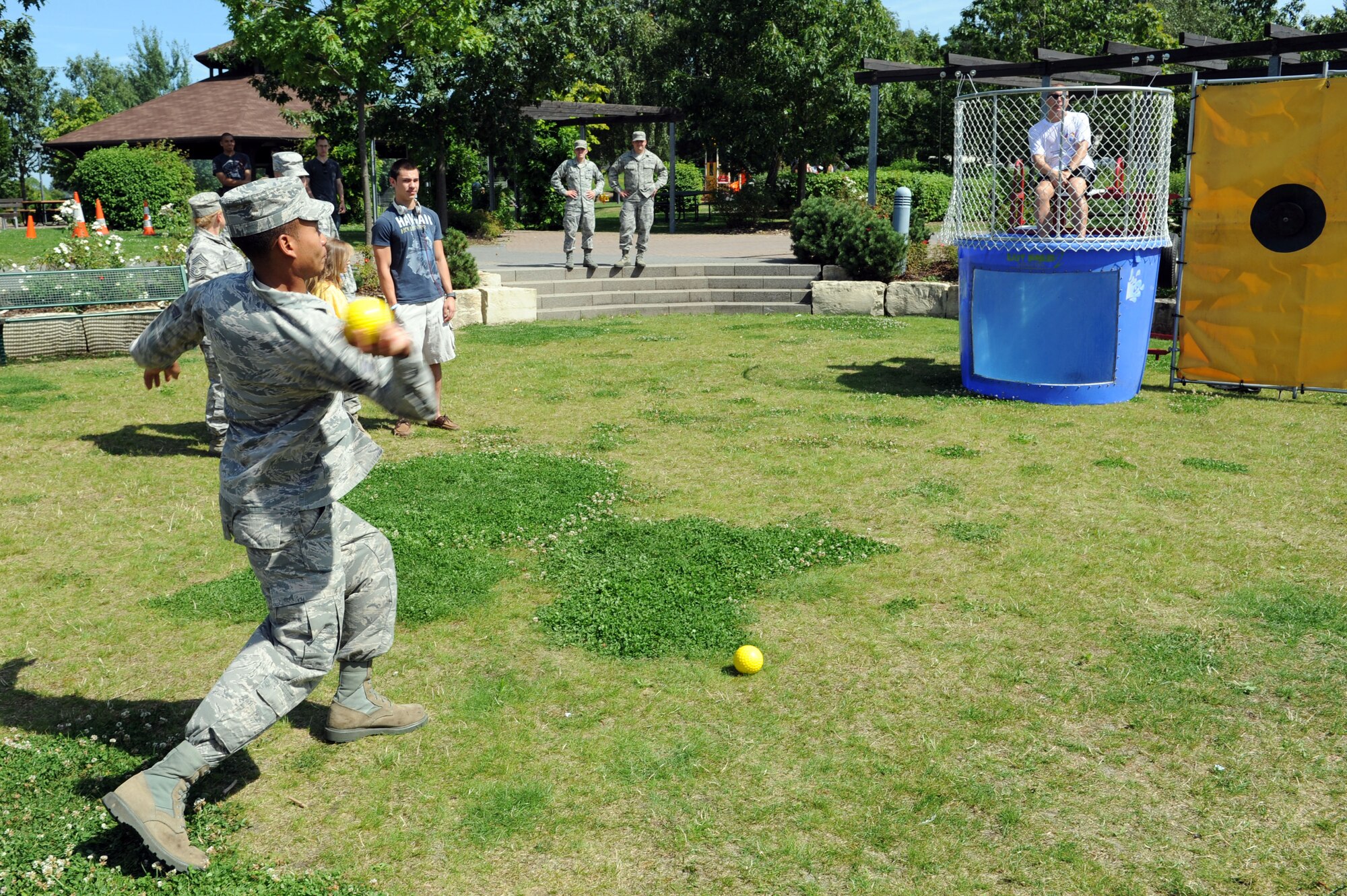 SPANGDAHLEM AIR BASE, Germany – Senior Airman Christopher Lyn, 606th Air Control Squadron, attempts to dunk Chief Master Sgt. Matthew Grengs, 52nd Fighter Wing command chief, during an unaccompanied Airmen block party at the wing pavilion here Aug. 17. The event included a drunk goggles obstacle course, sumo wrestling, Polynesian dancers, dunk tank and a comedy performance. The first sergeants council and the Spangdahlem chiefs group hosted the event. (U.S. Air Force photo by Senior Airman Christopher Toon/Released)