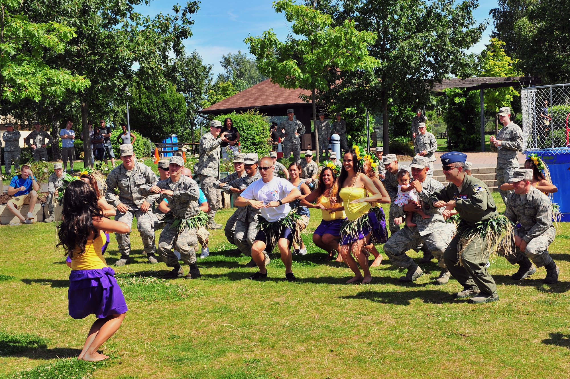 SPANGDAHLEM AIR BASE, Germany – Airmen from the 52nd Fighter Wing, along with wing leadership, participate in a Polynesian dance during an unaccompanied Airman block party at the wing pavilion here Aug. 17. The event included a drunk goggles obstacle course, sumo wrestling, Polynesian dancers, dunk tank and a comedy performance. The first sergeants council and the Spangdahlem chiefs group hosted the event to help boost morale among unaccompanied Airmen. (U.S. Air Force photo by Airman 1st Class Dillon Davis/Released)