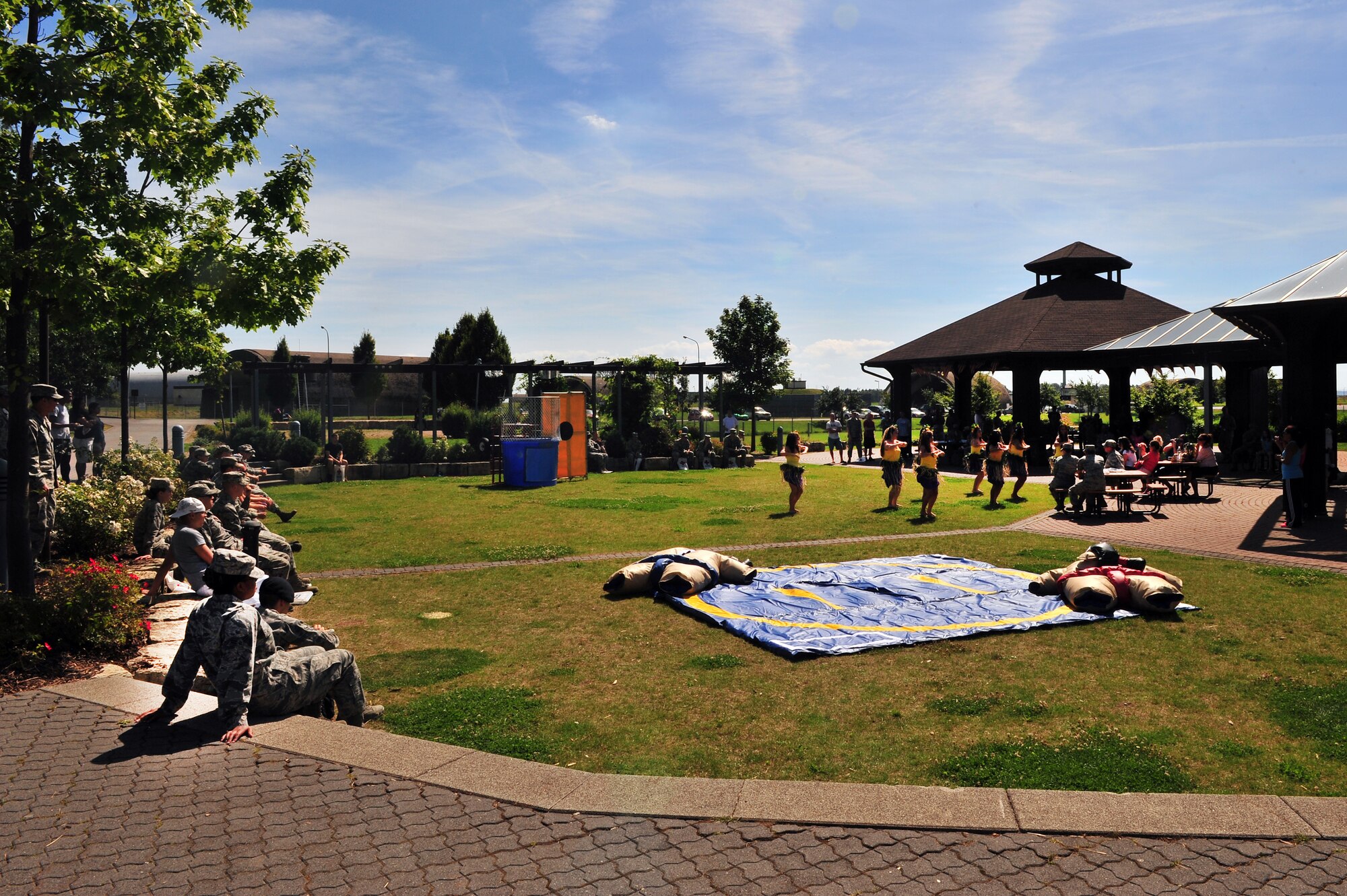 SPANGDAHLEM AIR BASE, Germany – Airmen from the 52nd Fighter Wing watch a Polynesian dance presentation during an unaccompanied Airman block party at the wing pavilion here Aug. 17. The event included a drunk goggles obstacle course, sumo wrestling, Polynesian dancers, dunk tank and a comedy performance. The first sergeants council and the Spangdahlem chiefs group hosted the event to help boost morale among unaccompanied Airmen. (U.S. Air Force photo by Airman 1st Class Dillon Davis/Released)