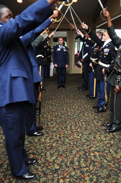 U.S. Air Force Staff Sgt. Benjamin Seekell, 4th Security Forces Squadron military working dog handler, prepares to walk under an arch of sabers during the Purple Heart Banquet at the Walnut Creek Country Club in Goldsboro, N.C., Aug. 10, 2012. Seekell was one of more than 40 Purple Heart recipients recognized at the dinner hosted by the Goldsboro/Wayne County Purple Heart Foundation. (U.S. Air Force photo/Airman 1st Class Aubrey Robinson/Released)