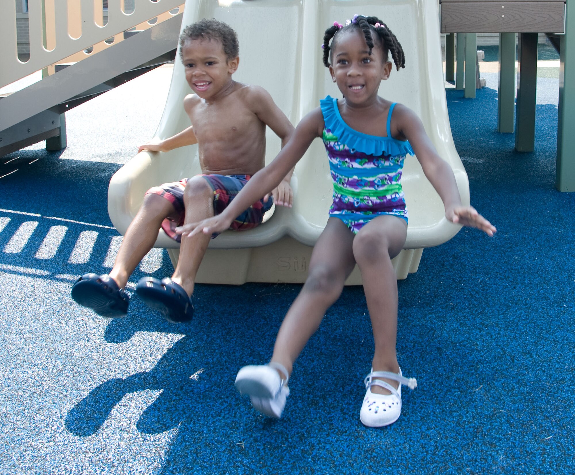 Timothy Bankole and Akayla Mosely play on the slide Aug. 17, 2012, at the Child Development Center on Dover Air Force Base, Del. Weekly prices for the CDC range from approximately $60-140 based on family income. (U.S. Air Force photo by Adrian R. Rowan)