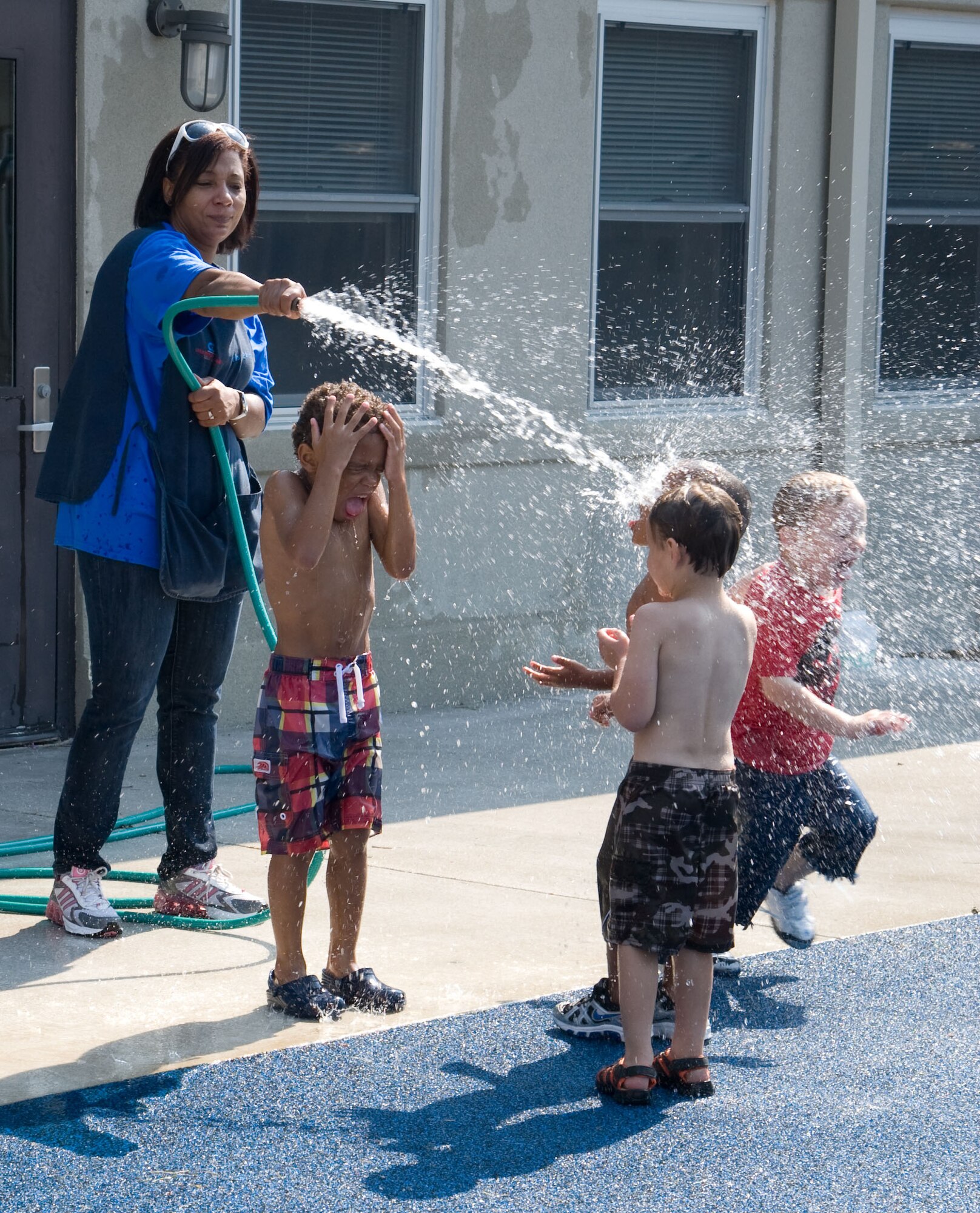 Students play in the water Aug. 17, 2012, at the Child Development Center on Dover Air Force Base, Del. The CDC’s staff looks after more than 200 children. (U.S. Air Force photo by Adrian R. Rowan)