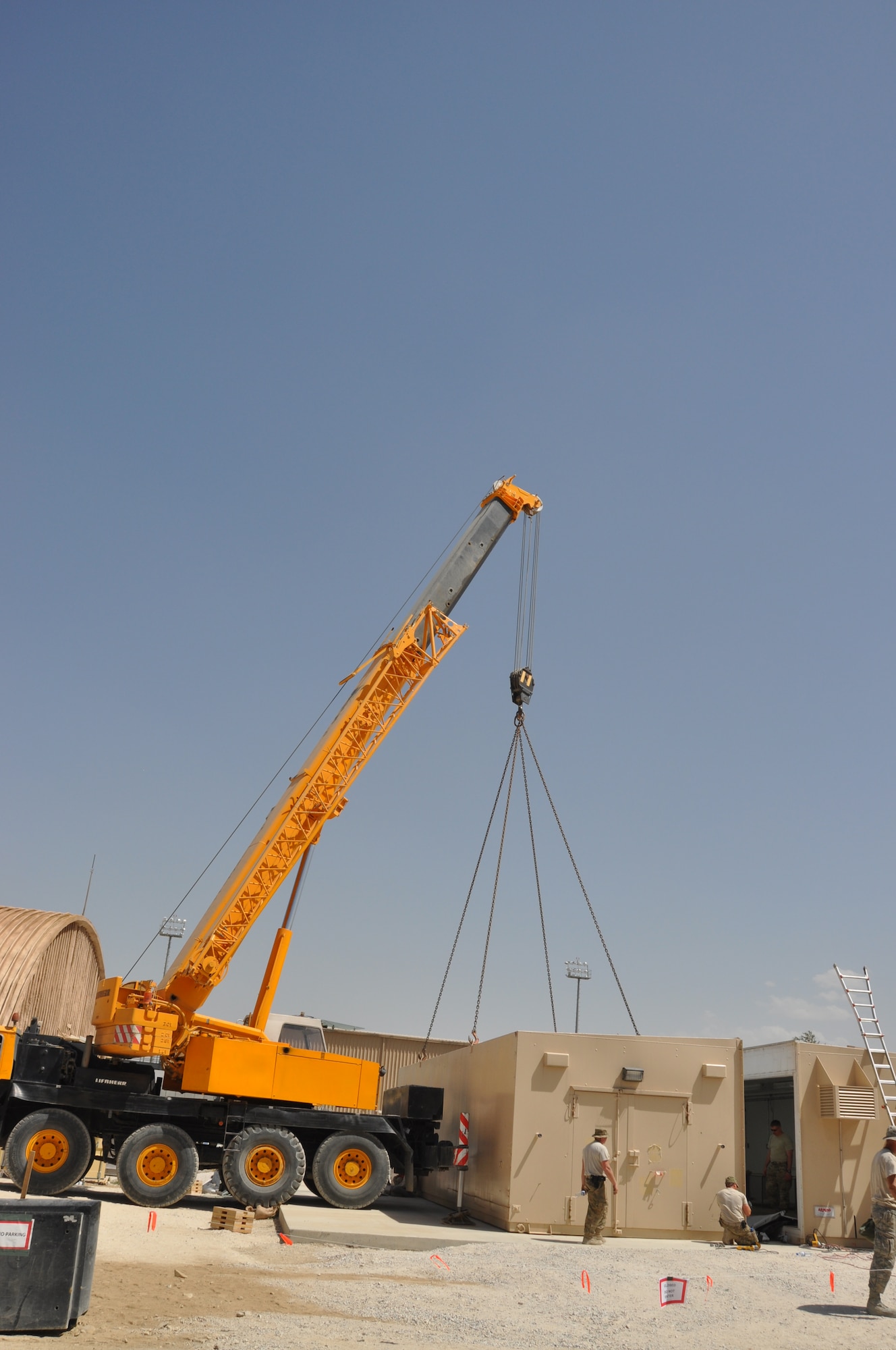 Members of 455th Air Expeditionary Wing's Expeditionary Civil Engineer Squadron, Expeditionary Logistics Readiness Squadron, and Expeditionary Security Forces Squadron, work together to install the wing's new weapons armory August 8, 2012 at Bagram Airfield, Afghanistan. Knicknamed the "ARMAG,"  the new facility combined weapons from three temporary storage facilities into a more secure and climate-controlled building. (U.S. Air Force photo/TSgt Shawn McCowan)