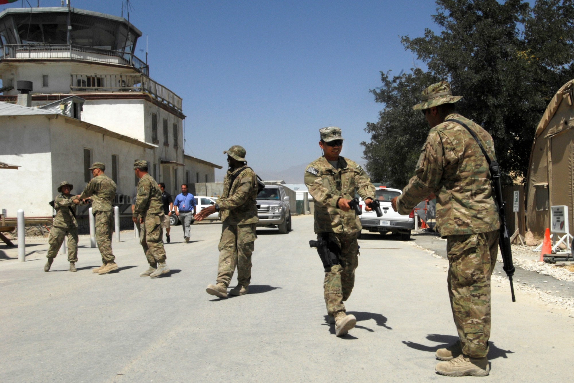 Airmen assigned to the 455th Air Expeditionary Wing form a line to pass weapons from temporary storage to a new armory in Camp Cunningham at Bagram Airfield, Afghanistan, Aug. 19, 2012. About 50 Airmen volunteered to move as many as a 1, 000 M-9s and M-16s from an older armory to a new, better equipped and more secure armory which is climate-controlled.  Weapons will be stored in the new hardened facility permanently. (U.S. Air Force photo/SSgt Jeff Nevison)