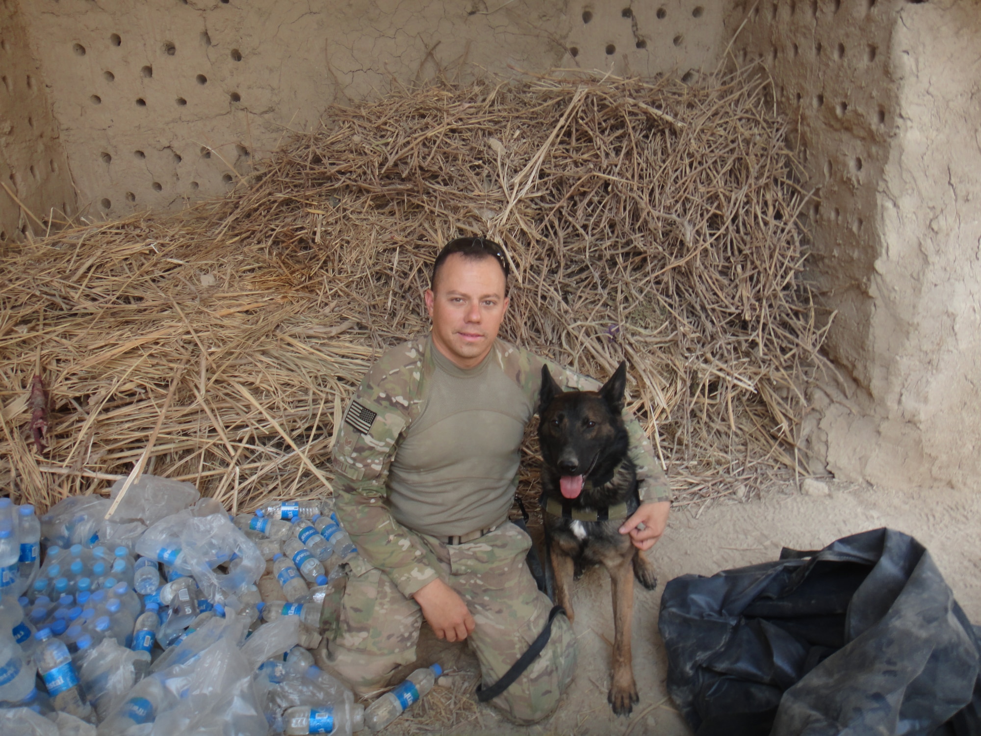 Staff Sgt. Christopher Jarrell, 81st Security Forces kennel master, poses for a photo with Military Working Dog, Toki, while deployed in Afghanistan.  Jarrell has been selected for the Secretary of the Air Force’s “Portraits in Courage” for 2012. (Courtesy photo.)