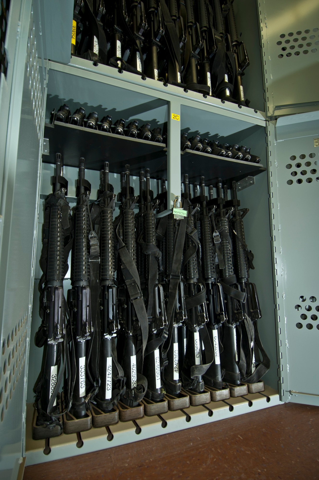 Several M-16 assault rifles and M-9 pistols sit in a locker at Camp Cunningham’s new armory facility at Bagram Airfield, Afghanistan, Aug. 20, 2012. The weapons were relocated from three different armories across Bagram to be consolidated in one centralized and secure storage facility. (U.S. Air Force photo/Capt. Raymond Geoffroy)