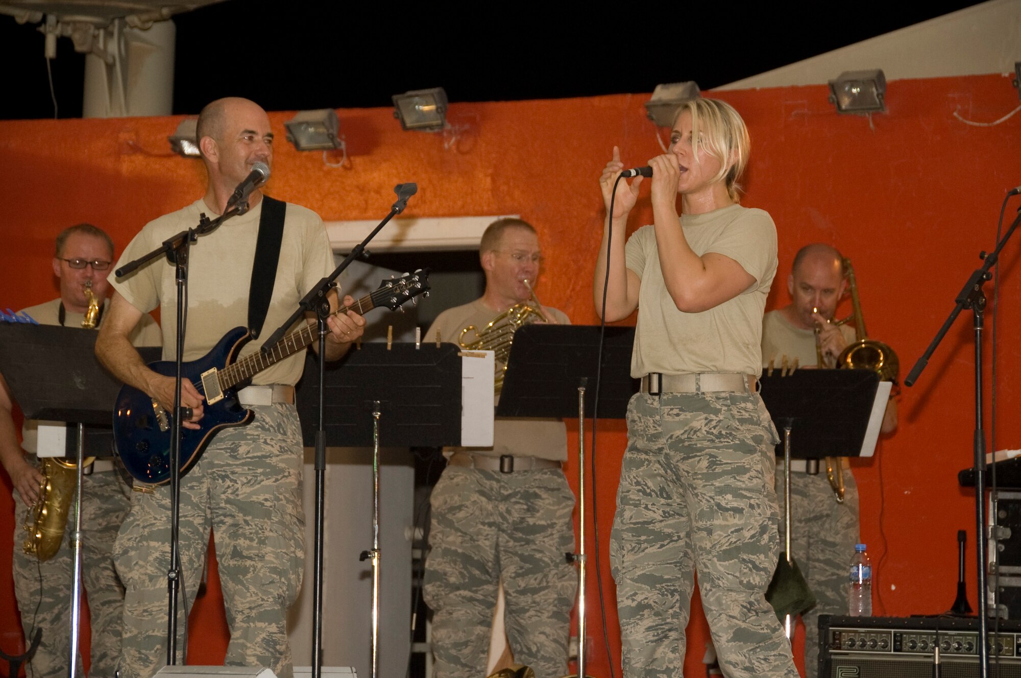 Senior Airman Jamie Horner, 379th Expeditionary Civil Engineer Squadron emergency manager, caught the eye of the Air Force Central Band’s director of operations after singing in the finals of the 379th Force Support Flight singing competition, The Voice. Horner began singing with the band during local performances due to their lack of a female vocalist. Horner is deployed from Andrews Air Force Base, Md., and is a native of Redding, Calif. (U.S. Air Force photo/Senior Airman Bryan Swink)