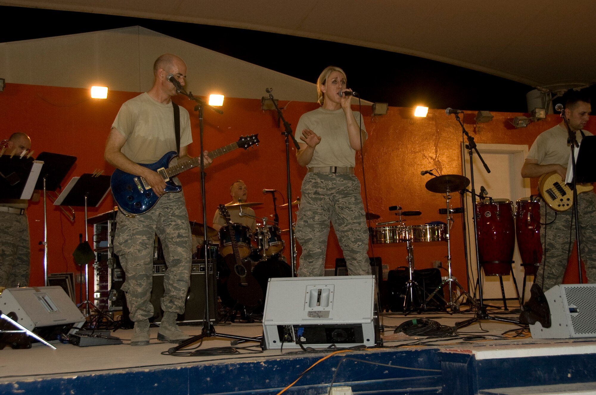 Senior Airman Jamie Horner, 379th Expeditionary Civil Engineer Squadron emergency manager, sings with the Air Force Central Band, Vector, during their final local performance Aug. 18 at Memorial Plaza. Horner began singing with Vector due to their lack of a female vocalist. Horner is deployed from Andrews Air Force Base, Md., and is a native of Redding, Calif. (U.S. Air Force photo/Senior Airman Bryan Swink)